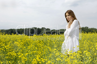 brunette woman in a yellow flowers field