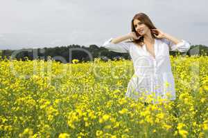 brunette woman in a yellow flowers field