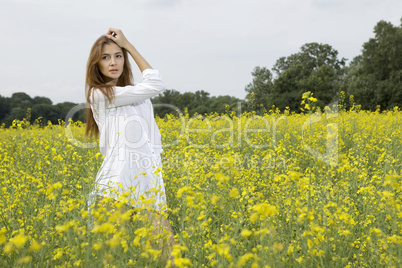 brunette woman in a yellow flowers field