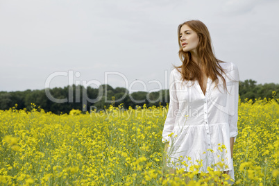 brunette woman in a yellow flowers field