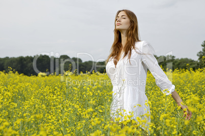 brunette woman in a yellow flowers field