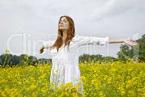 Beautiful woman in a yellow flowers field