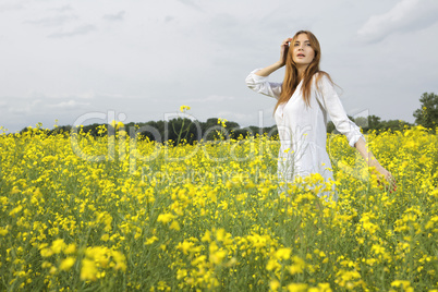brunette woman in a yellow flowers field