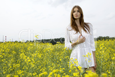 brunette woman in a yellow flowers field