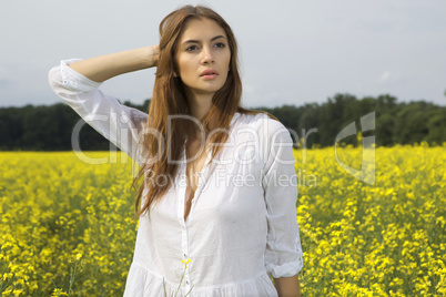 brunette woman in a yellow flowers field