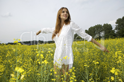 brunette woman in a yellow flowers field