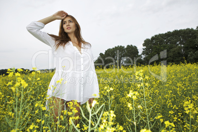 brunette woman in a yellow flowers field