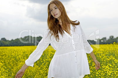 Beautiful woman in a yellow flowers field