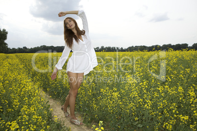 brunette woman in a yellow flowers field