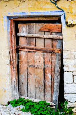 Weathered red door in a village