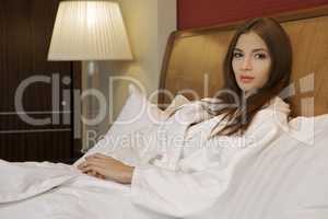 Beautiful woman on a bed and pillow
