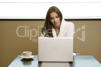 Young woman looks at her laptop computer