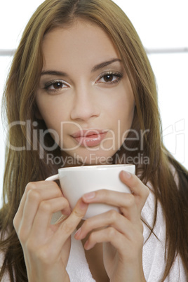 Portrait of cute teenage girl with cup of coffee