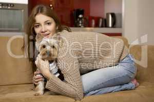 Cute young girl with her Yorkie puppy