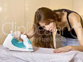 young woman ironing on ironing board