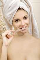 young beautiful woman brushing her teeth