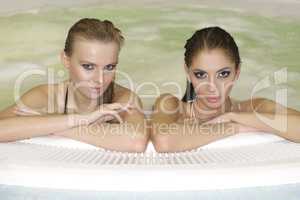 Two young beautiful girls in jacuzzi