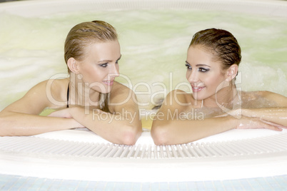 Two young beautiful girls in jacuzzi