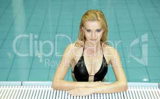 beautiful young woman standing in a swimming pool