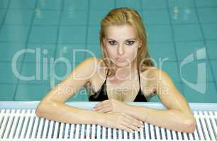 beautiful young woman standing in a swimming pool