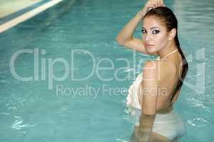 beautiful young woman standing in a swimming pool