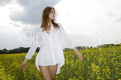 brunette woman in a yellow flowers field