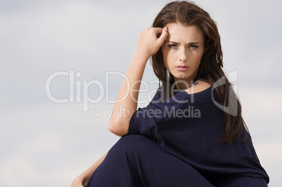 Sexy brunette posing in violet dress.