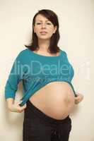 Beautiful pregnant woman - isolated over a light background