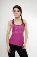 sporty woman in violet dress standing and looking on camera