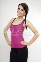 sporty woman in violet dress standing and looking on camera
