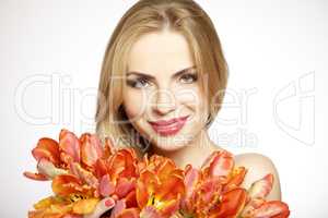 Beautiful blonde girl with the bouquet of tulips isolated on a w