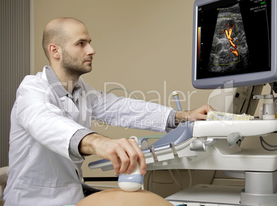 Portrait of young male technician operating ultrasound machine