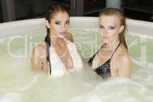 Two young beautiful girls in jacuzzi