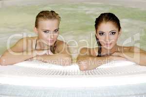 Two young beautiful girls in jacuzzi