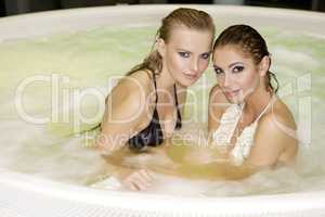 Two young beautiful girls in jacuzzi