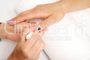 Manicure - Beautiful manicured woman's nails with violet nail po