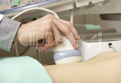 Pregnant woman getting ultrasound from doctor