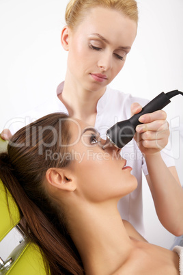 Young woman receiving laser therapy