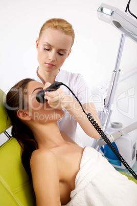 Young woman receiving laser therapy