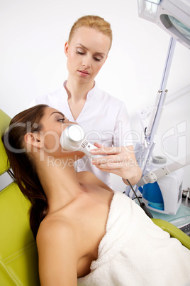 Young woman receiving laser therapy