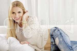 Beautiful and attractive blonde woman posing in blue jeans dress