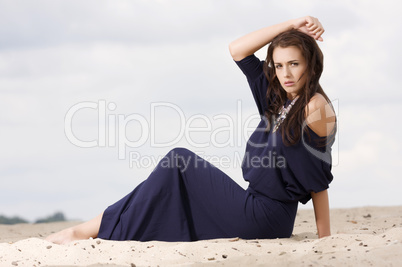 Sexy brunette posing in violet dress.