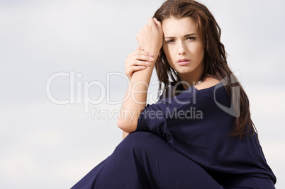 Sexy brunette posing in violet dress.