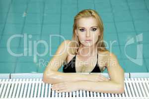 beautiful young woman standing in a swimming pool