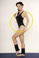 Beautiful sporty woman in black dress slim body with hula hoop