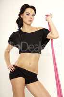 Beautiful sporty woman in black dress slim body with sash