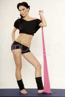 Beautiful sporty woman in black dress slim body with sash