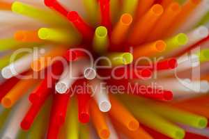 Collection colored drinking straws in blur.
