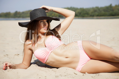 beautiful brunette woman in pink bikini