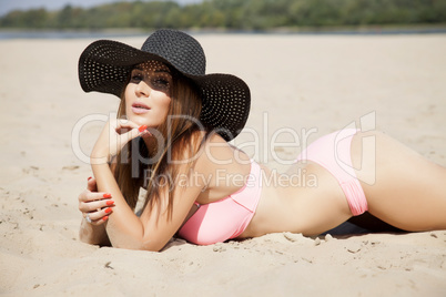 beautiful brunette woman in pink bikini